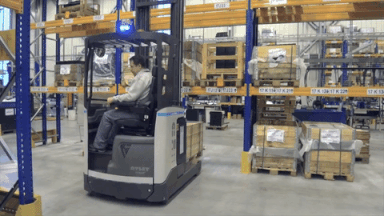A typical reach truck has to turn before leaving the aisle with a pallet